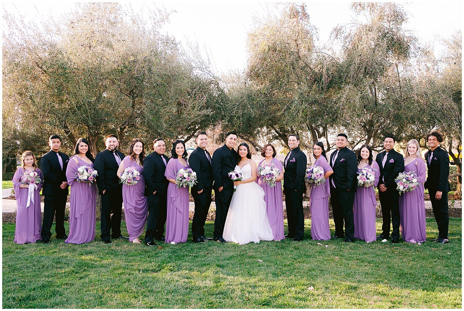 Large wedding party in black and purple