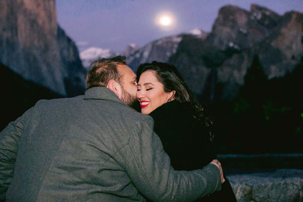 Couple embraces during yosemite proposal at Taft Point in Yosemite National Park