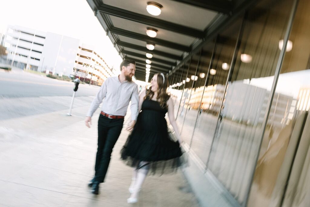 Couple walking hand-in-hand with motion blur during a fun courthouse wedding session in Fresno